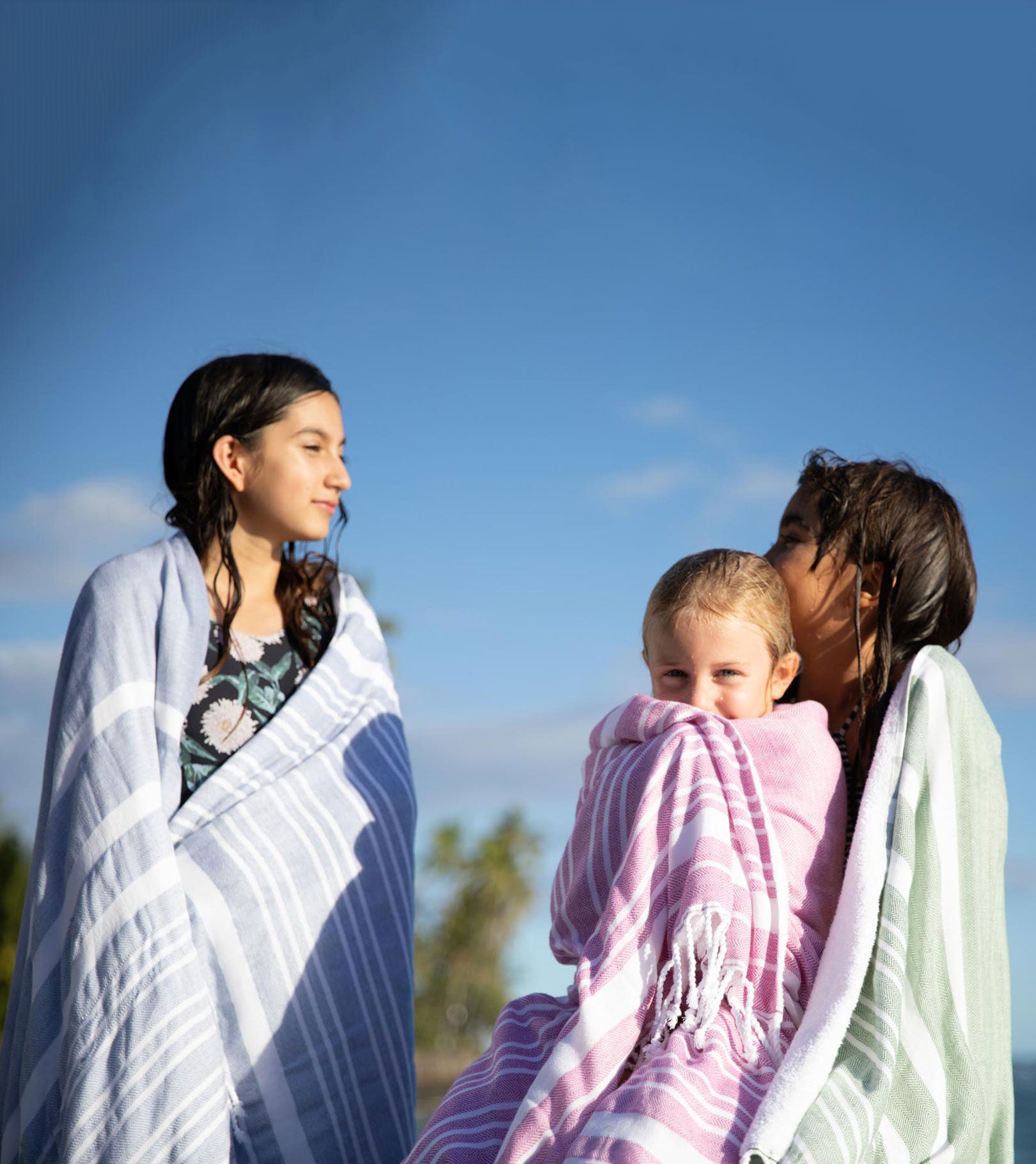 Averylily Swim, Surf + Sand Fouta Beach Towels in Ocean Blue, Orchid Pink, and Palm Green.