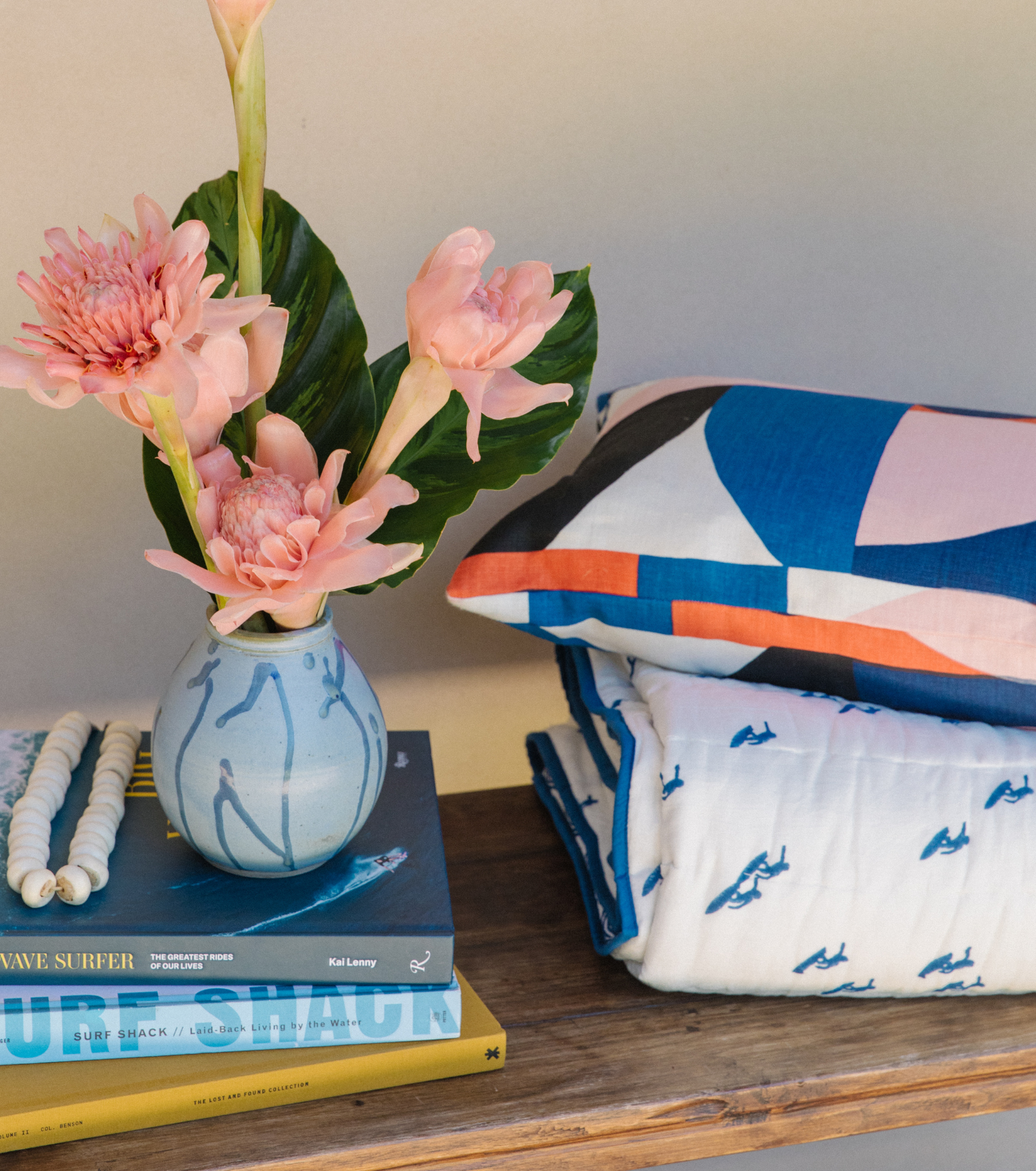 Andrew Mau x Averylily Surfer Blockprint Quilt in Ocean Blue, styled with a Serena Dugan Studio pillow.