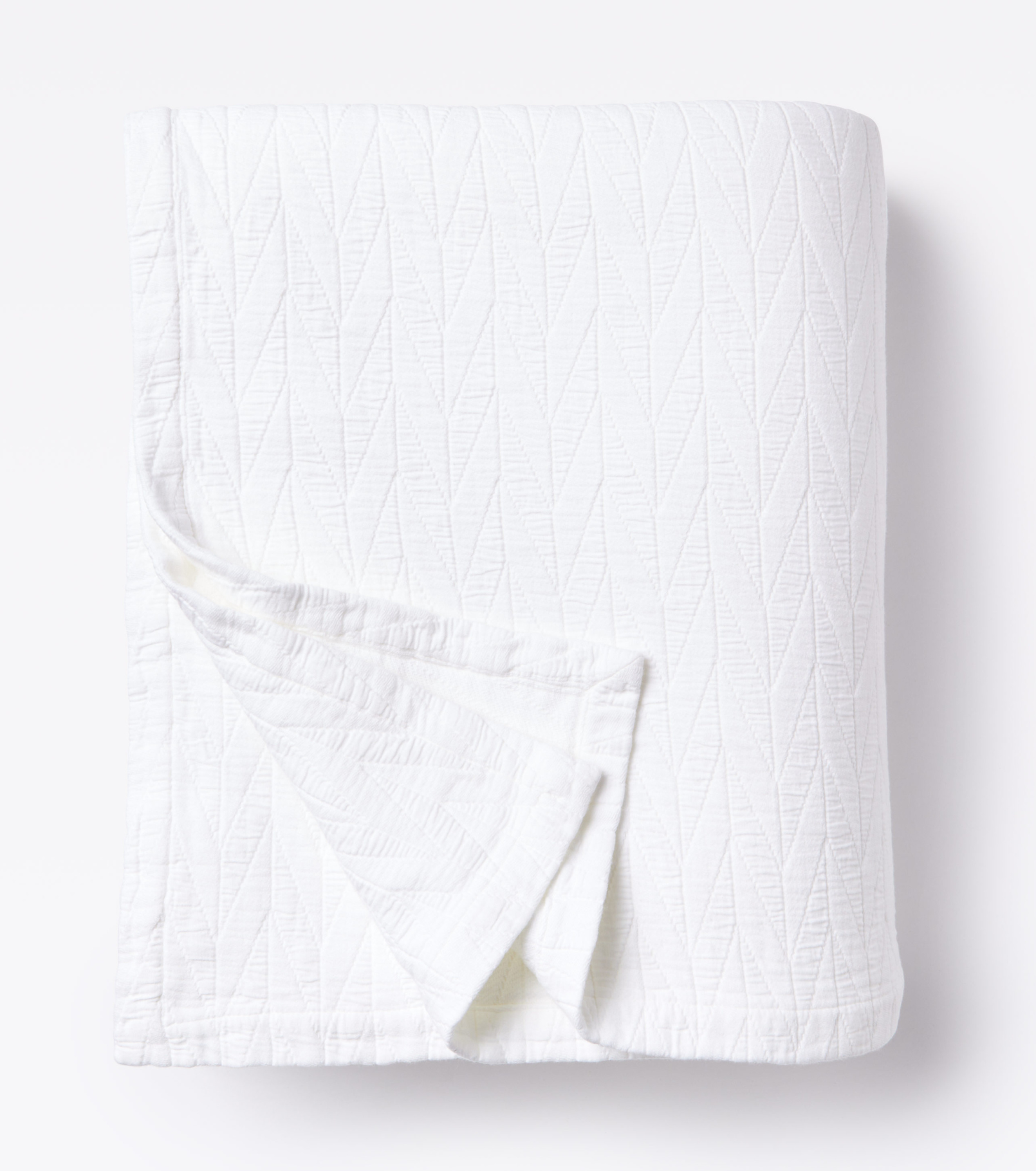 Averylily pure cotton matelassé coverlet. Each coverlet features a herringbone design that is unique to Averylily. Shown here in White Cloud.