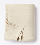 Averylily pure cotton matelassé coverlet. Each coverlet features a herringbone design that is unique to Averylily. Shown here in Sand.