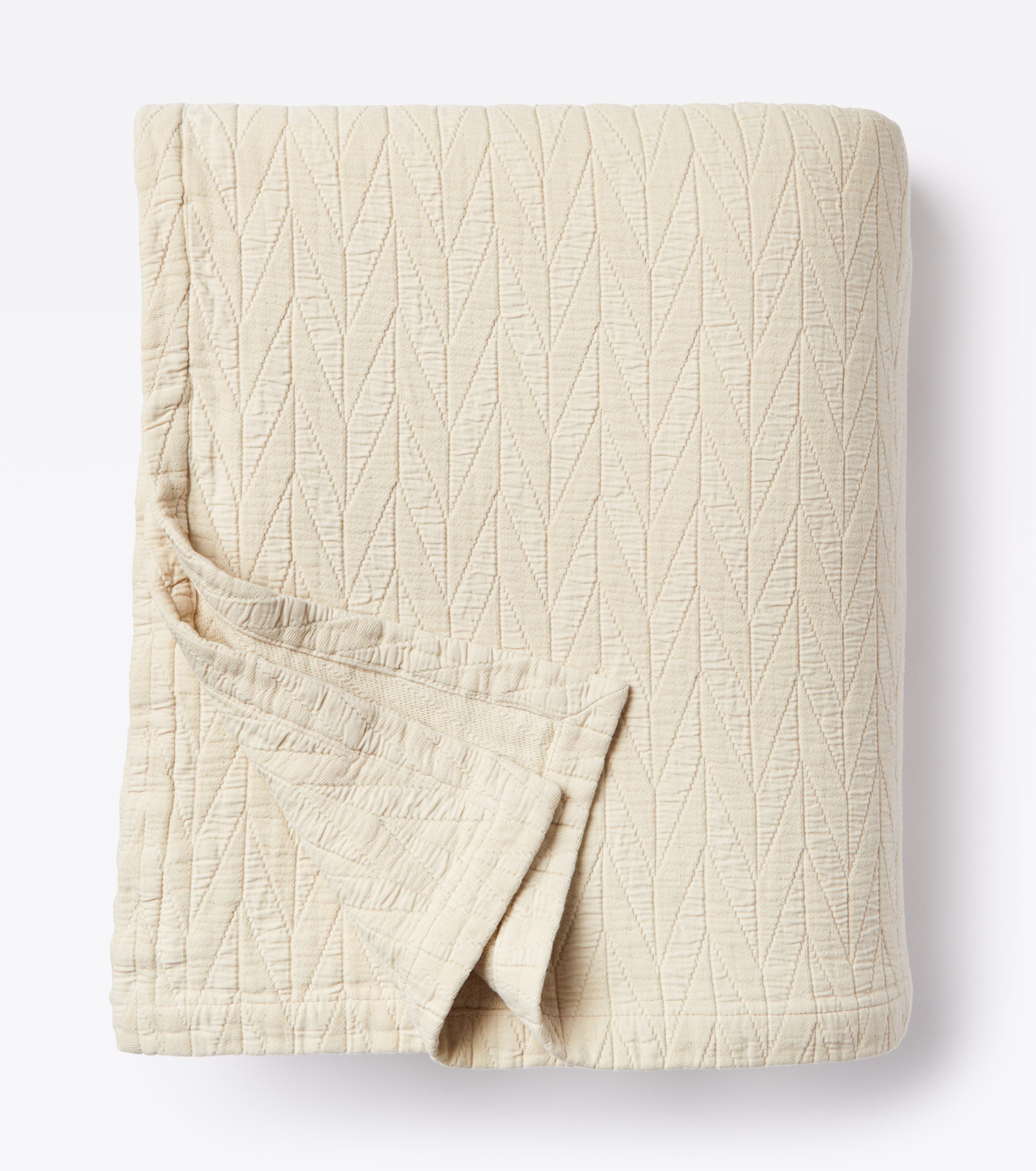 Averylily pure cotton matelassé coverlet. Each coverlet features a herringbone design that is unique to Averylily. Shown here in Sand.
