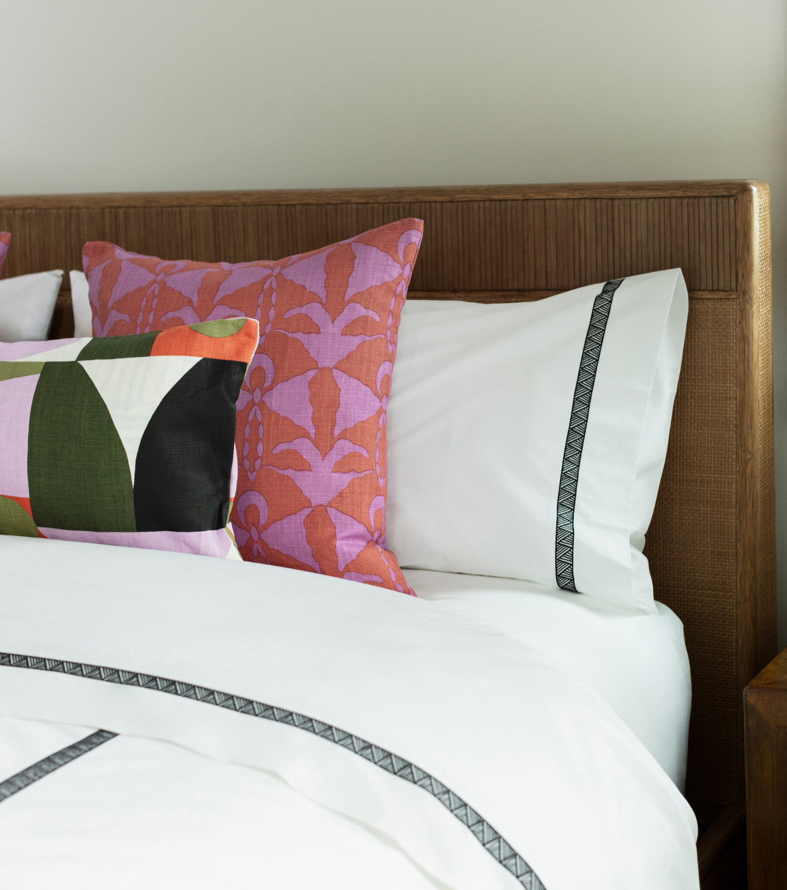 Averylily Weave Duvet Cover in White with embroidered trim in Basalt. 510-thread count cotton percale. Styled with Serena Dugan Studio decorative pillows.