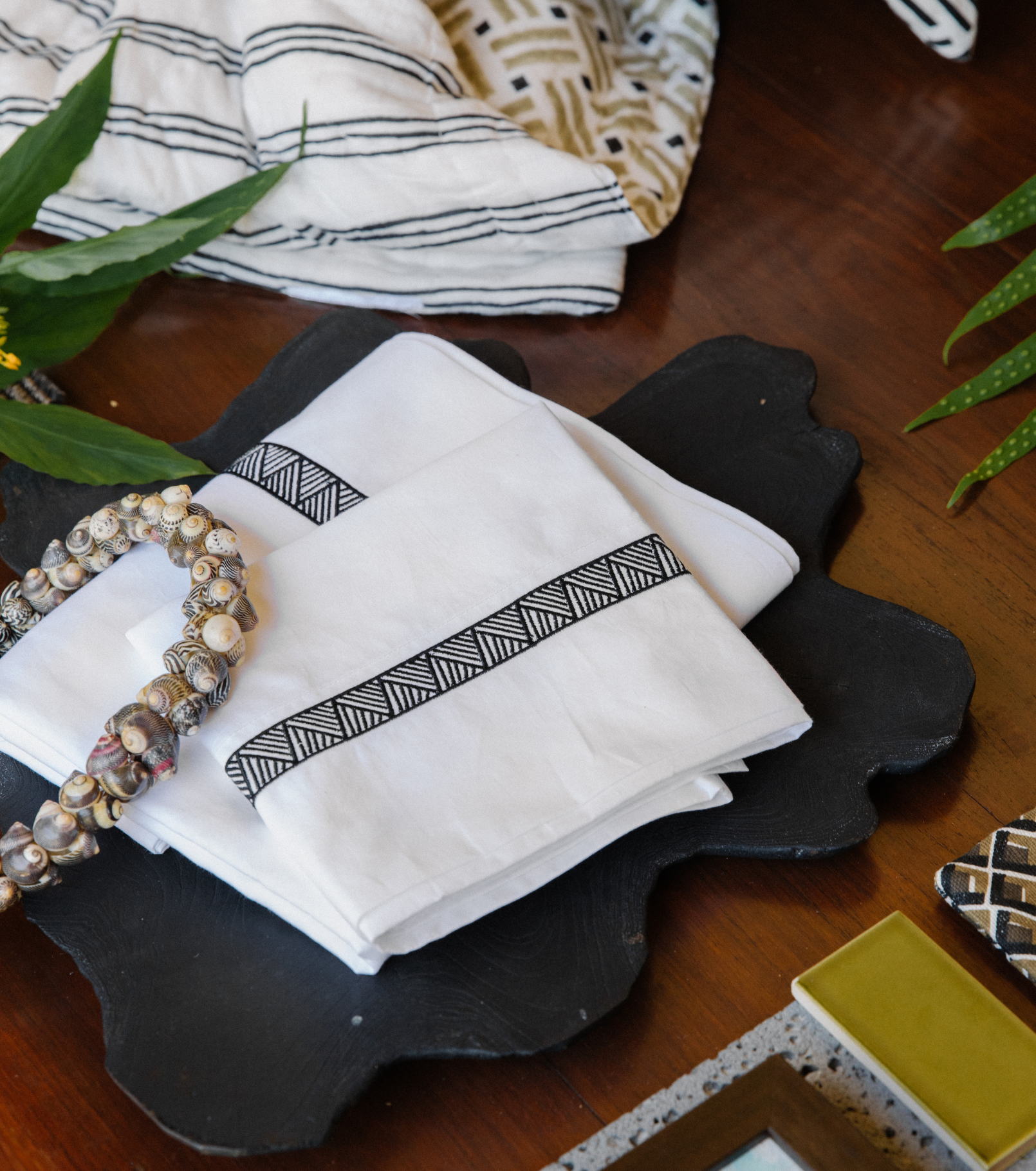 Averylily Weave Sheet Set in White with embroidered trim in Basalt. Styled with Averylily Big Island Quilt in Sand & Basalt.