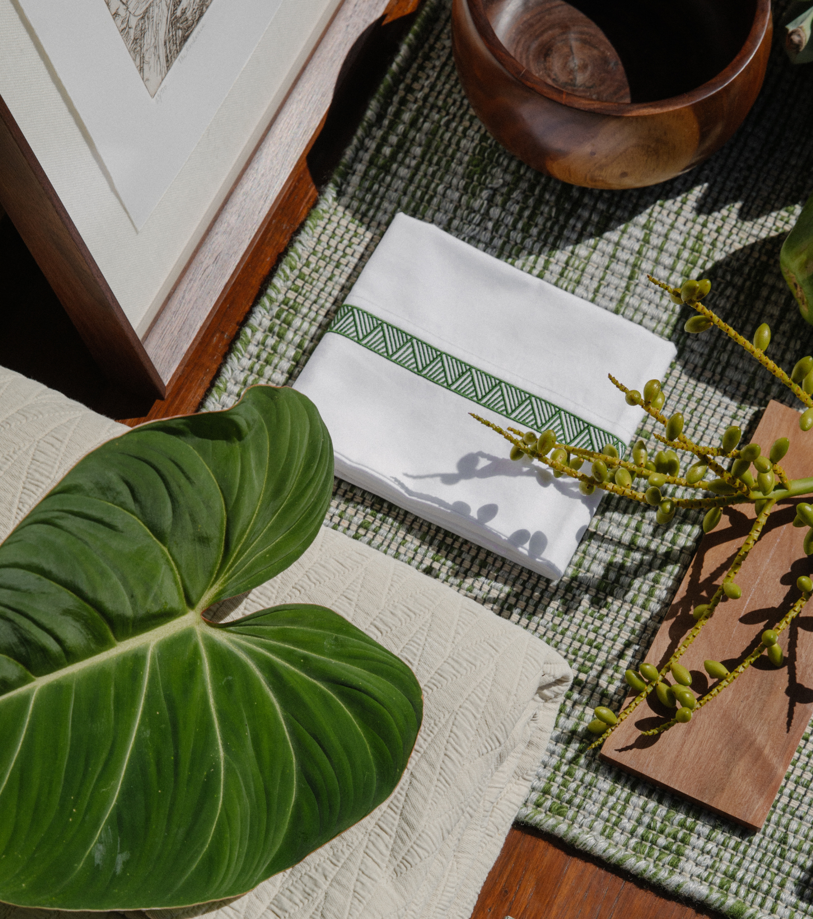 Averylily Weave Sheet Set in White with embroidered trim in Palm Green. Styled with Averylily Watermark Coverlet in Sand.