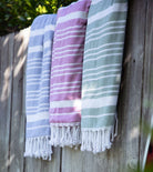 Averylily Swim, Surf + Sand Fouta Beach Towels in Ocean Blue, Orchid Pink, and Palm Green.