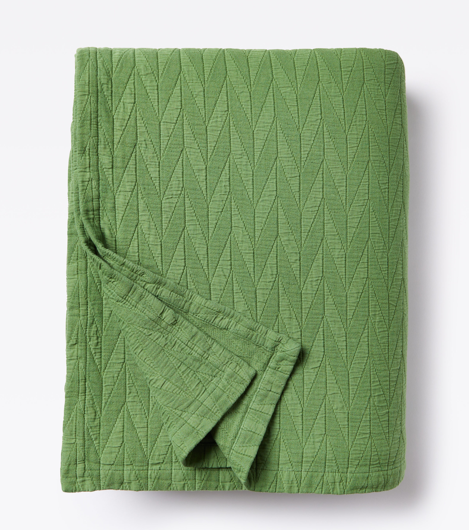 Averylily pure cotton matelassé coverlet. Each coverlet features a herringbone design that is unique to Averylily. Shown here in Palm Green.