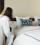 Averylily Weave Duvet Cover in White with embroidered trim in Ocean Blue. 510-thread count cotton percale. Styled with Serena Dugan Studio decorative pillows.